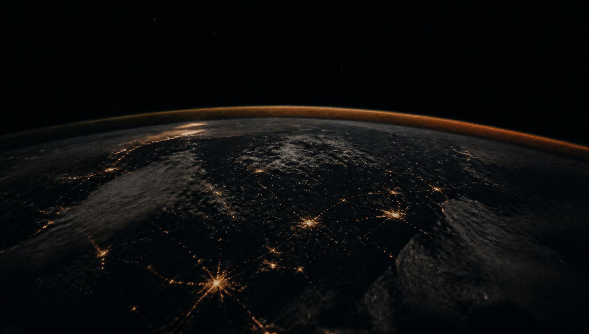 Earth's horizon glowing at night